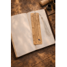 Quicksilver wooden bookmark, back view, placed on an open book
