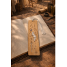 Quicksilver wooden bookmark, front view, placed on an open book