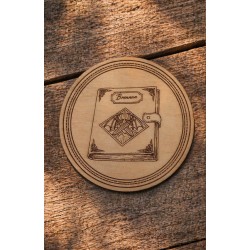 Fourth Wing - Engraved wooden coaster depicting Brennan's journal placed on a wooden table