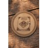 Fourth Wing - Engraved wooden coaster depicting Brennan's journal placed on a wooden table